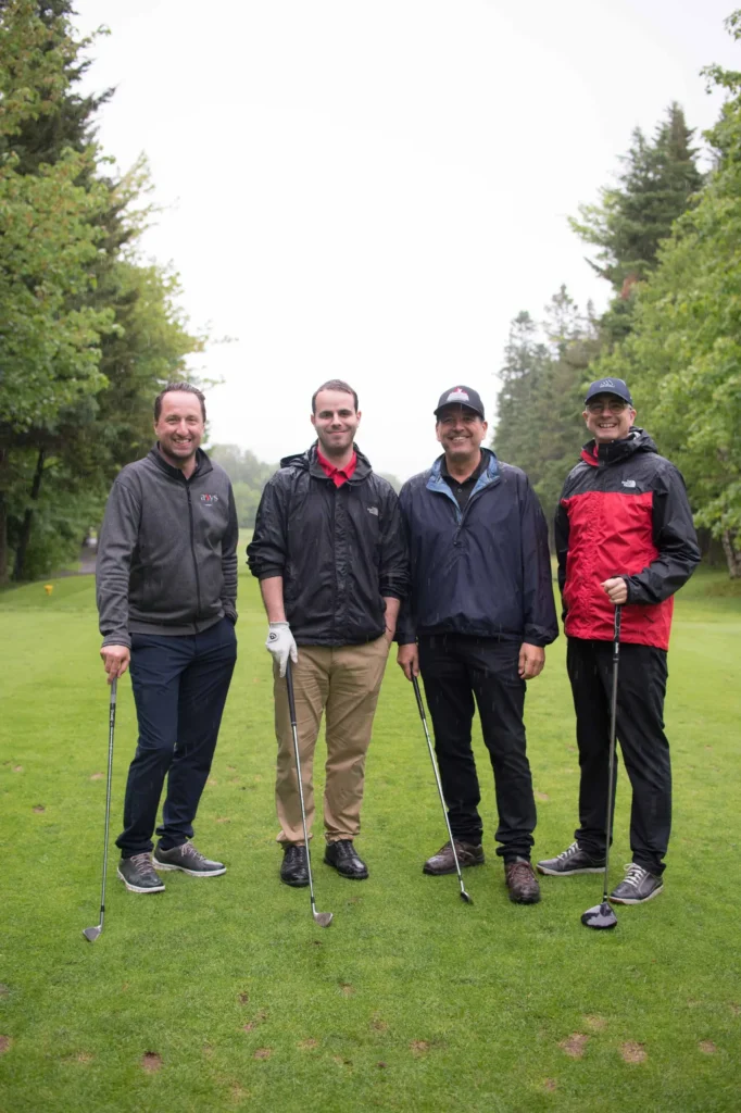 Quatre hommes avec clubs sur un golf