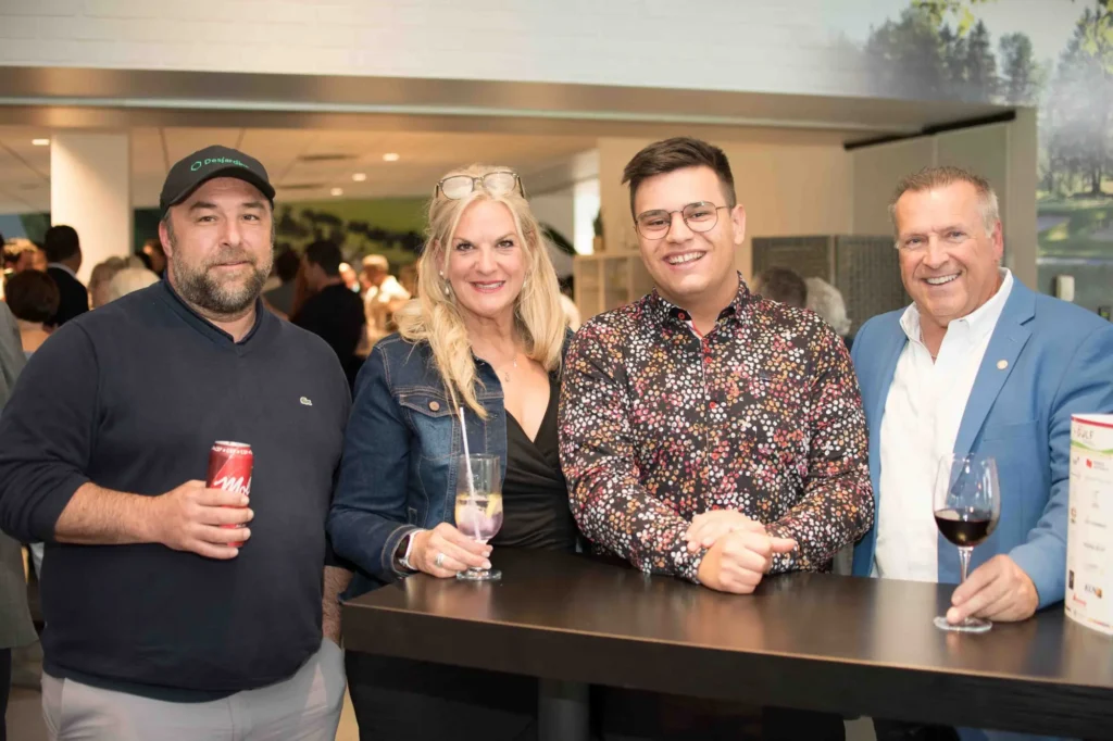 Quatre adultes souriants lors d’un événement convivial